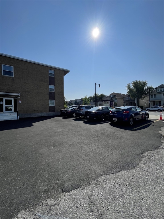 720 Bennington Street, Unit 207 Boston, MA 02128 - Photo 9 of 9 a cars parked in front of a house