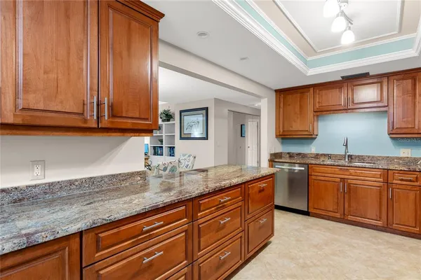 a kitchen with stainless steel appliances granite countertop a sink stove microwave refrigerator and cabinets