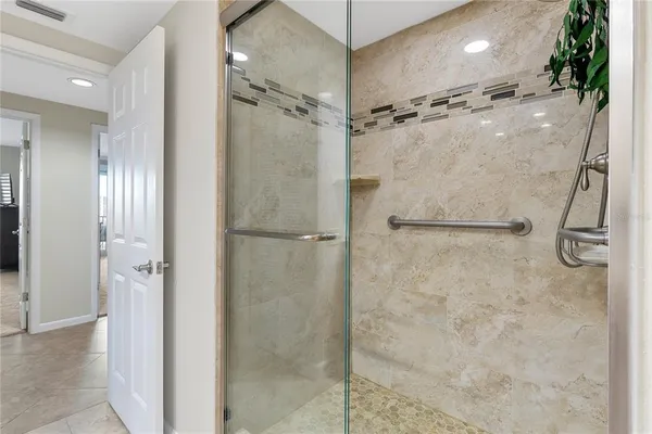 a view of a hallway with bathroom and a bathroom
