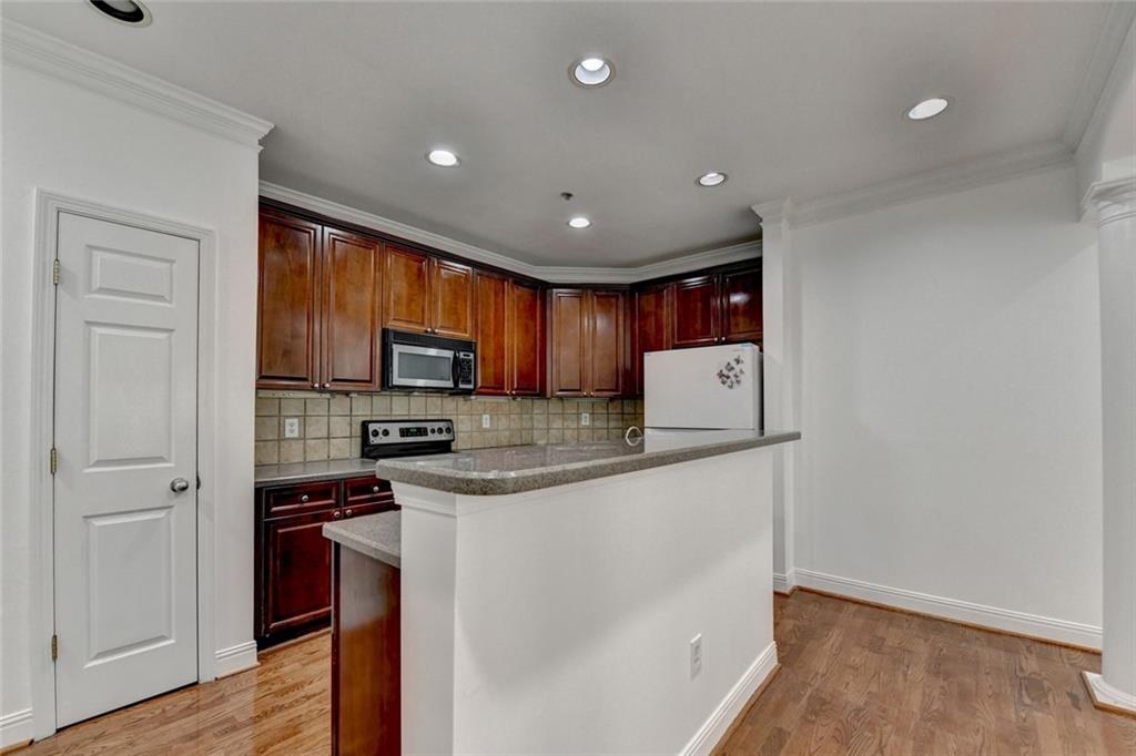2202 Stratford Commons Decatur, GA 30033 - Photo 11 of 38 a kitchen with stainless steel appliances granite countertop a stove a sink and a refrigerator