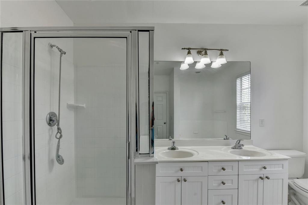 2202 Stratford Commons Decatur, GA 30033 - Photo 28 of 38 a bathroom with a granite countertop sink a shower and a mirror