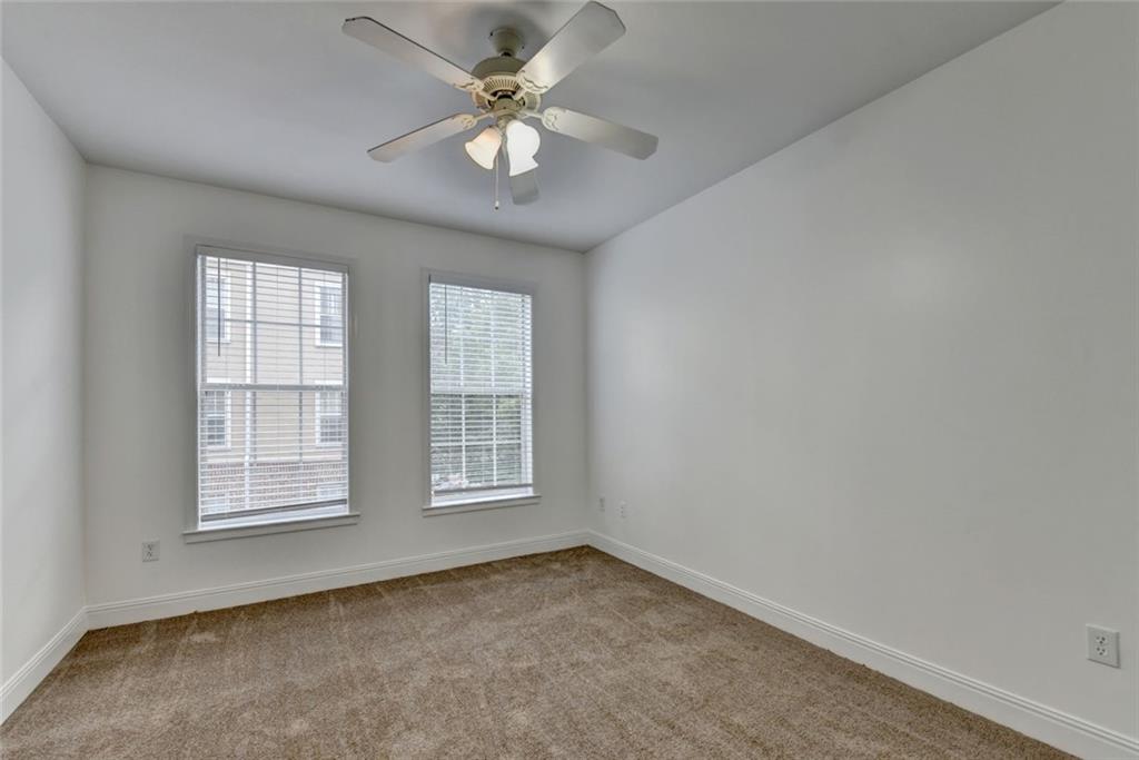 2202 Stratford Commons Decatur, GA 30033 - Photo 30 of 38 an empty room with chandelier fan and windows