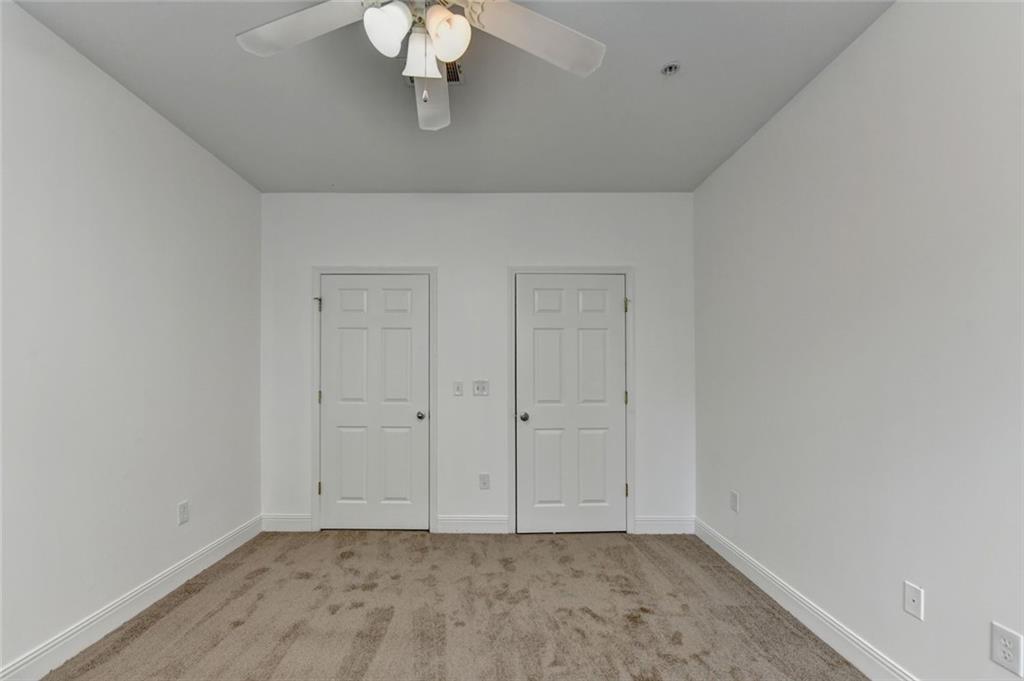 2202 Stratford Commons Decatur, GA 30033 - Photo 31 of 38 an empty room with a chandelier fan