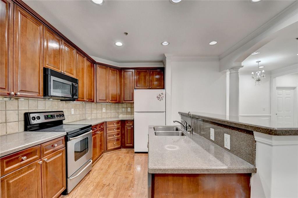 2202 Stratford Commons Decatur, GA 30033 - Photo 4 of 38 a kitchen with stainless steel appliances granite countertop a sink a stove top oven a counter space and cabinets