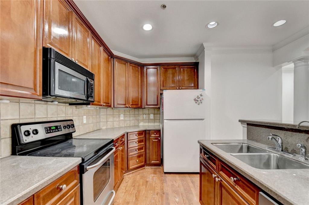 2202 Stratford Commons Decatur, GA 30033 - Photo 5 of 38 a kitchen with stainless steel appliances granite countertop a sink stove microwave and refrigerator