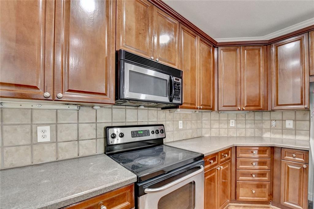 2202 Stratford Commons Decatur, GA 30033 - Photo 6 of 38 a kitchen with stainless steel appliances granite countertop a sink stove and microwave