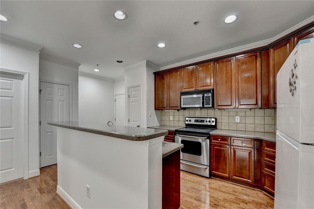 2202 Stratford Commons Decatur, GA 30033 - Photo 8 of 38 a kitchen with stainless steel appliances granite countertop a stove top oven a sink and a granite counter tops