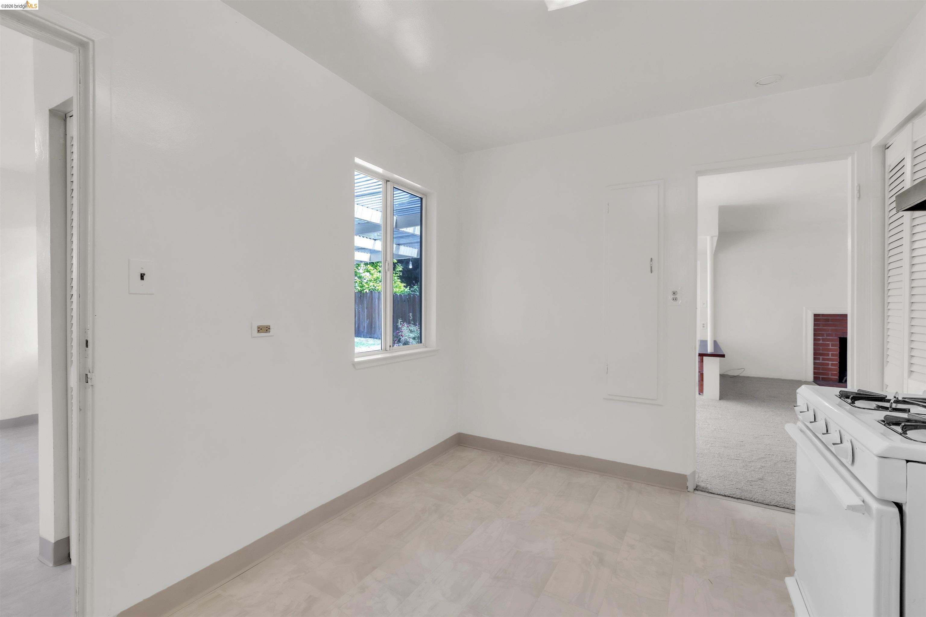 621 Paseo Del Rio San Lorenzo, CA 94580 - Photo 8 of 24 Bright interior space featuring light-toned flooring, a window offering exterior views, and a white freestanding range