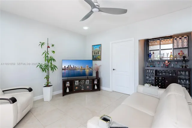 a living room with furniture and a potted plant