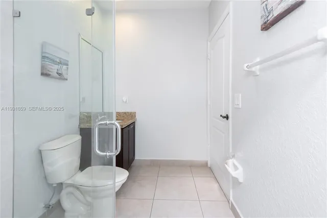 a white toilet sitting next to a bathroom sink