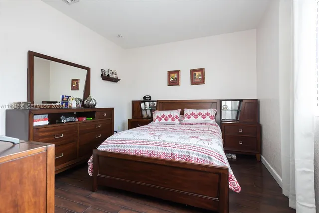 a bedroom with a bed and a dresser