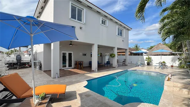 a view of a patio with swimming pool table and chairs
