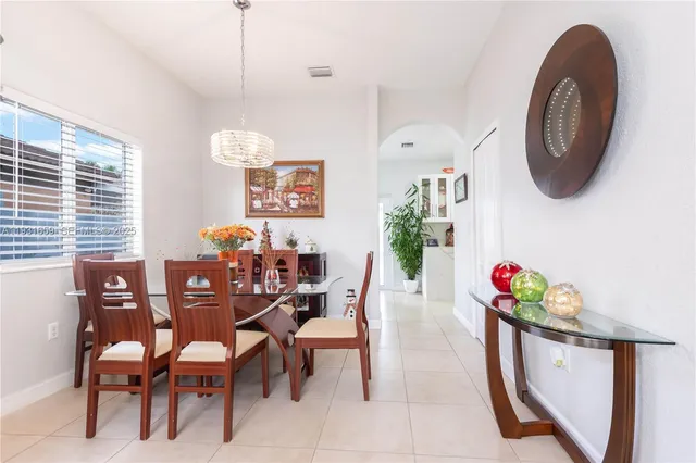 a view of a dining room with furniture and chandelier