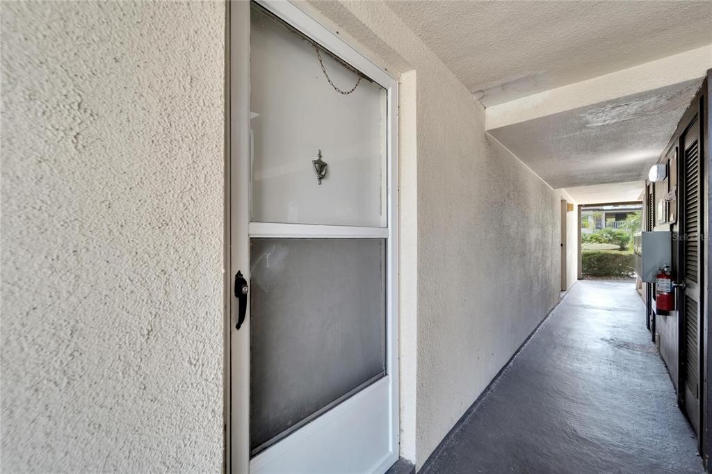 4600 Marine Parkway, Unit 104 New Port Richey, FL 34652 - Photo 13 of 69 a view of hallway with livingroom and wooden floor