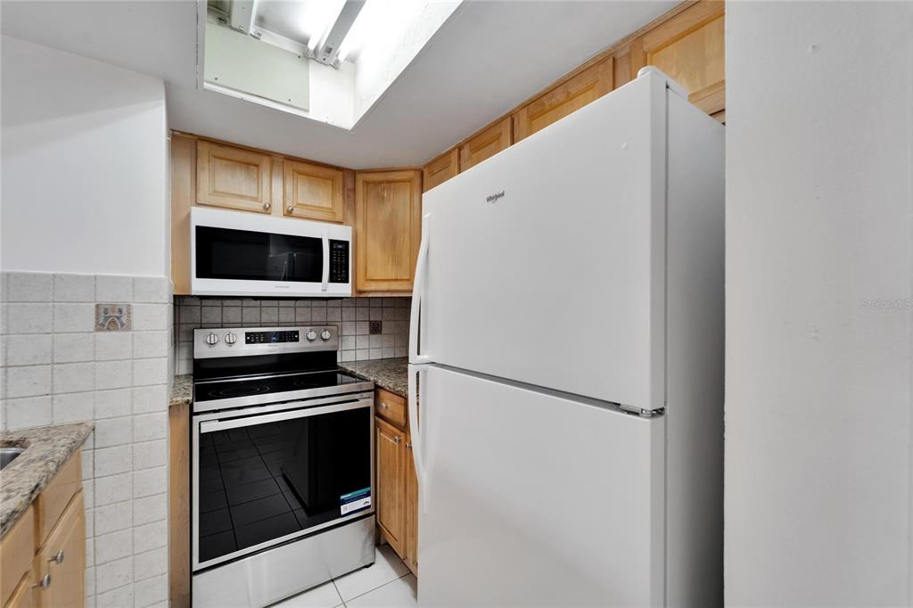 4600 Marine Parkway, Unit 104 New Port Richey, FL 34652 - Photo 23 of 69 a kitchen with a refrigerator stove and microwave