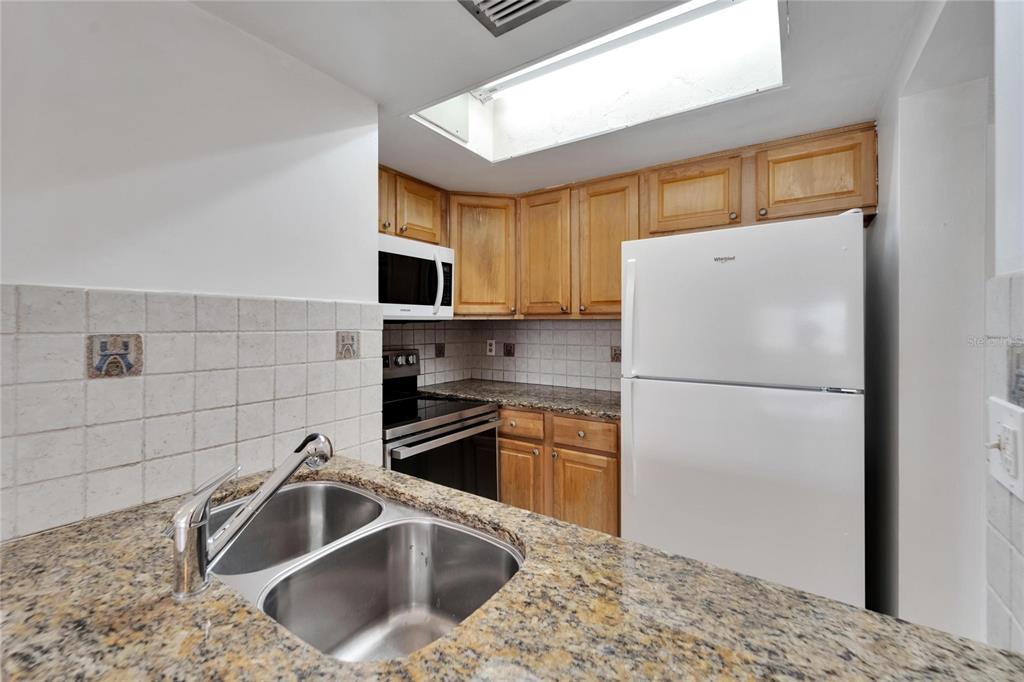 4600 Marine Parkway, Unit 104 New Port Richey, FL 34652 - Photo 27 of 69 a kitchen with a refrigerator sink and microwave