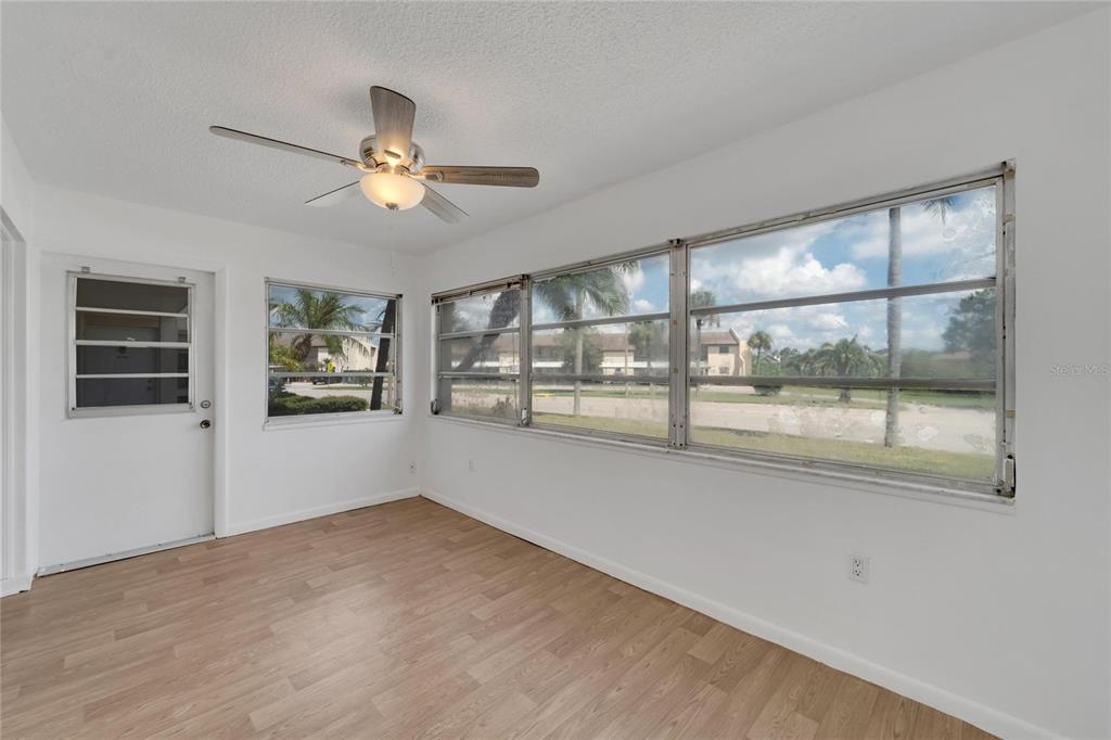 4600 Marine Parkway, Unit 104 New Port Richey, FL 34652 - Photo 29 of 69 a view of empty room with wooden floor and fan