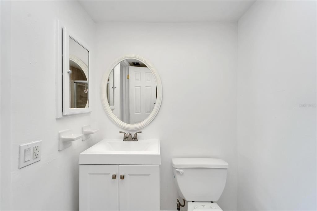 4600 Marine Parkway, Unit 104 New Port Richey, FL 34652 - Photo 40 of 69 a bathroom with a toilet sink and mirror
