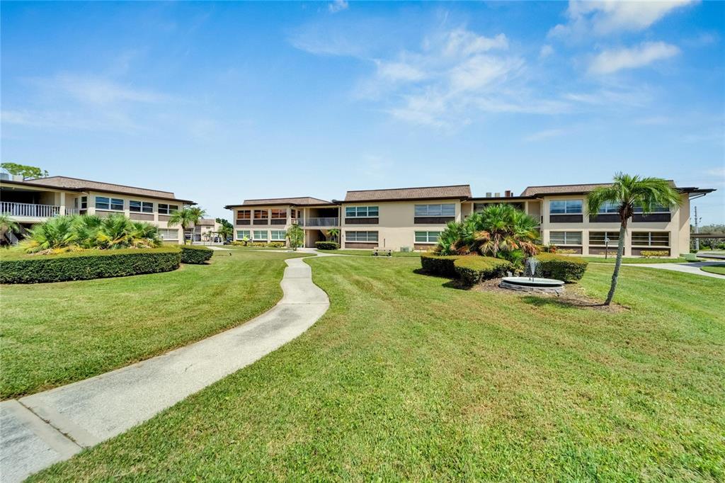 4600 Marine Parkway, Unit 104 New Port Richey, FL 34652 - Photo 44 of 69 a view of a house with a big yard and potted plants