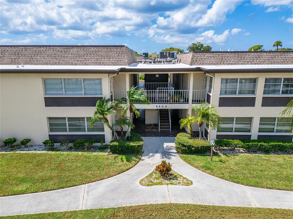 4600 Marine Parkway, Unit 104 New Port Richey, FL 34652 - Photo 48 of 69 front view of a house with a yard and potted plants