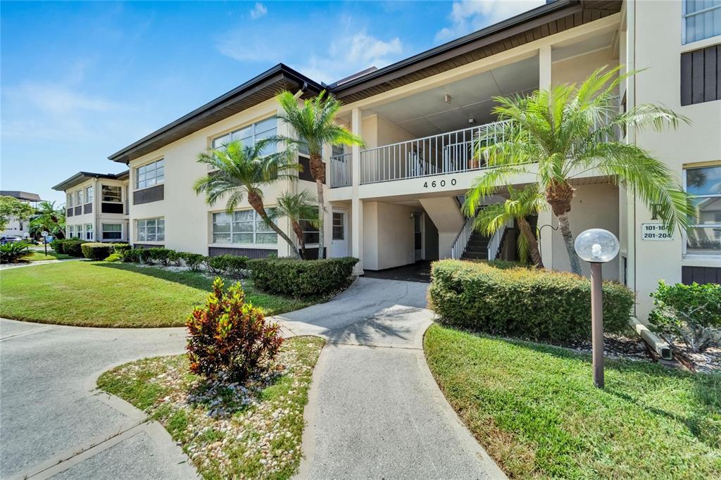 4600 Marine Parkway, Unit 104 New Port Richey, FL 34652 - Photo 5 of 69 a front view of a house with garden