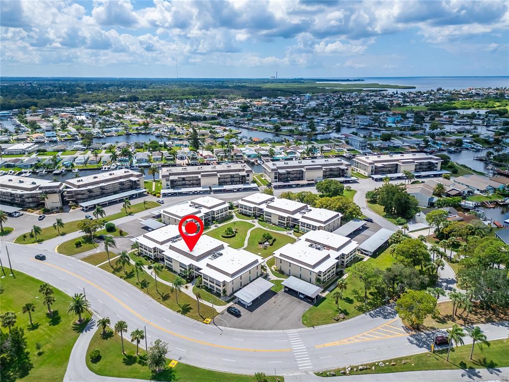 4600 Marine Parkway, Unit 104 New Port Richey, FL 34652 - Photo 54 of 69 an aerial view of a house with a swimming pool outdoor seating and yard