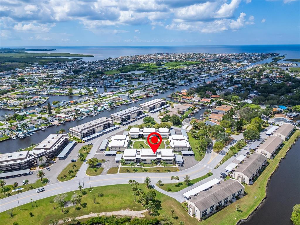 4600 Marine Parkway, Unit 104 New Port Richey, FL 34652 - Photo 55 of 69 an aerial view of residential houses with outdoor space and lake view