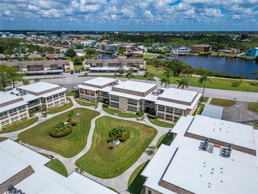 4600 Marine Parkway, Unit 104 New Port Richey, FL 34652 - Photo 60 of 69 an aerial view of a house with a garden and lake view