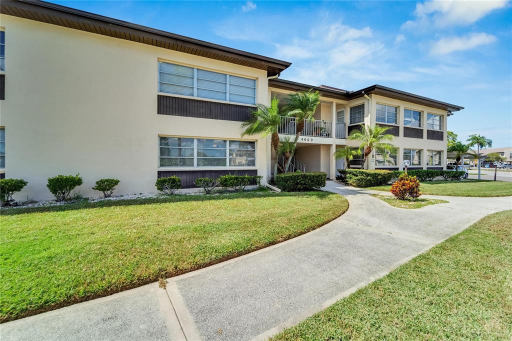 4600 Marine Parkway, Unit 104 New Port Richey, FL 34652 - Photo 9 of 69 a front view of a house with garden