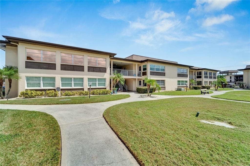 4600 Marine Parkway, Unit 104 New Port Richey, FL 34652 - Photo 10 of 69 a front view of a house with a yard