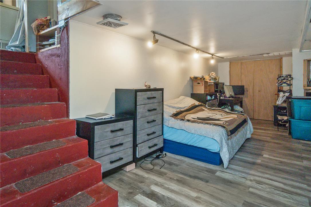3031 Shakespeare Road Bethlehem, PA 18017 - Photo 20 of 30 Hardwood-style flooring and track lighting illuminate this versatile space, featuring direct stair access.