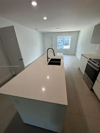 a kitchen with a sink and a stove top oven