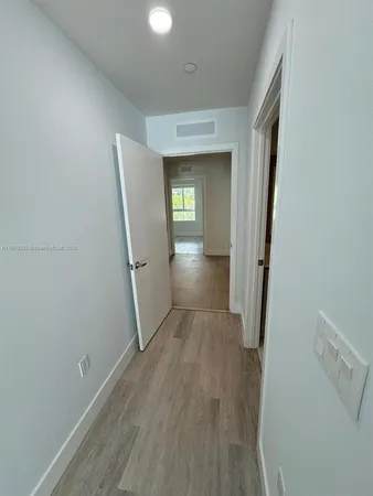 a view of a room with wooden floor and a staircase