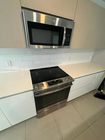 a kitchen with a stove and a microwave