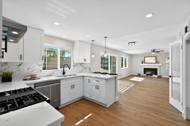 a kitchen with a sink cabinets and wooden floor