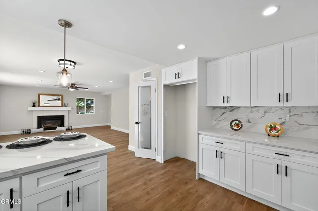 a kitchen with sink a stove and cabinets