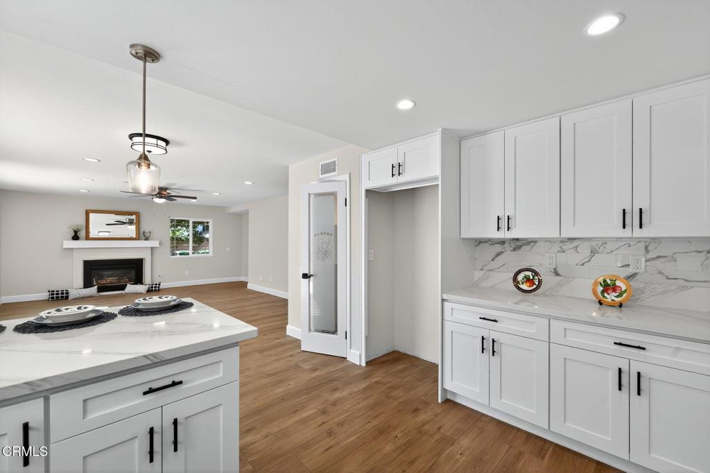2848 Jadestone Avenue Simi Valley, CA 93063 - Photo 12 of 31 a kitchen with a sink cabinets and wooden floor