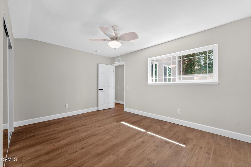 2848 Jadestone Avenue Simi Valley, CA 93063 - Photo 16 of 31 a view of an empty room with wooden floor and a window
