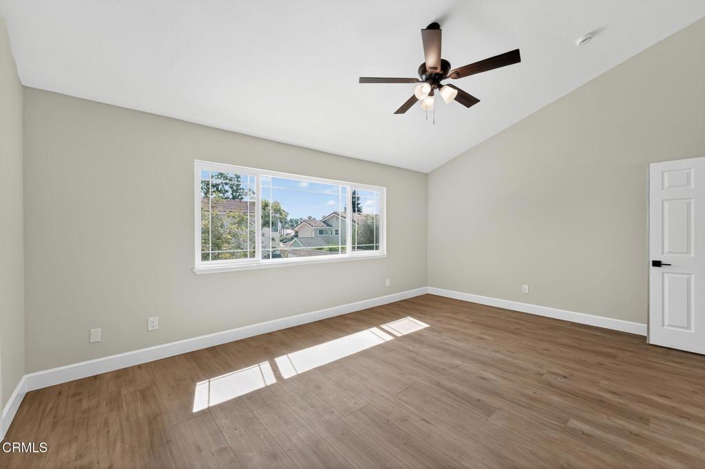 2848 Jadestone Avenue Simi Valley, CA 93063 - Photo 17 of 31 an empty room with wooden floor ceiling fan and window