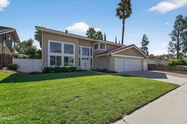 a front view of house with yard and trees