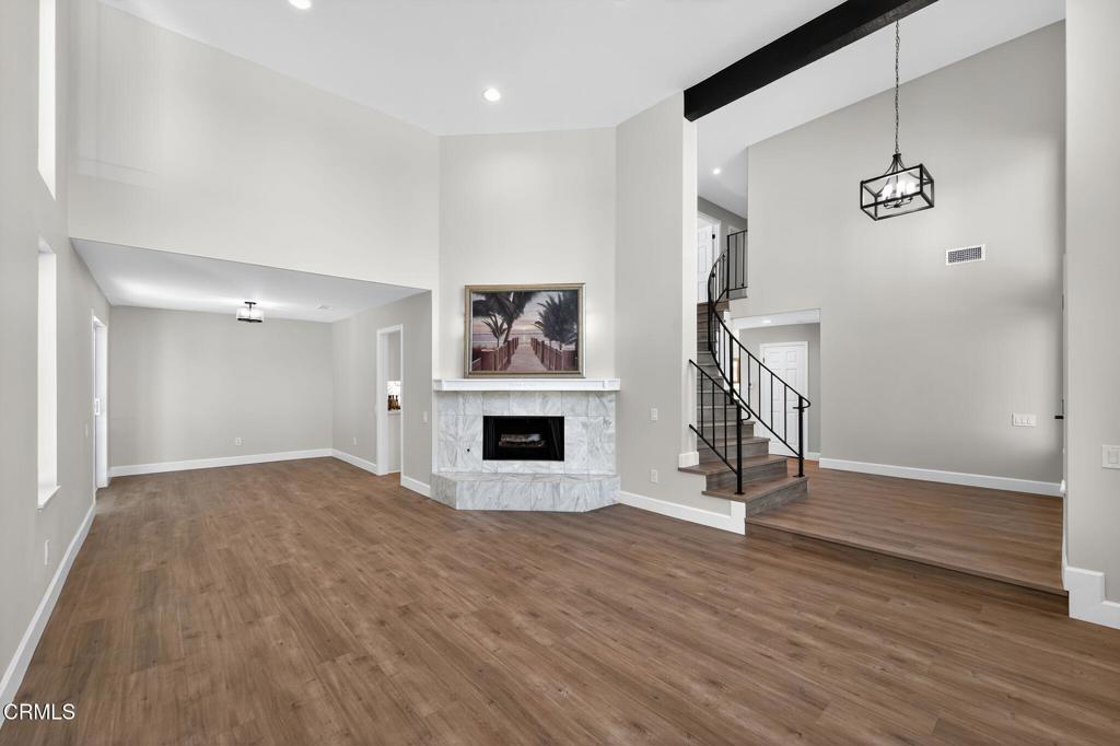 2848 Jadestone Avenue Simi Valley, CA 93063 - Photo 4 of 31 a view of empty room with wooden floor and fireplace