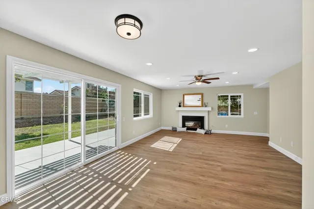 a kitchen with kitchen island a refrigerator a stove a sink and white cabinets
