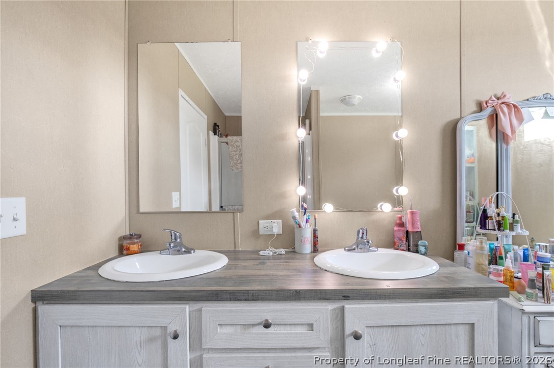 2452 Progressive Farm Road Fairmont, NC 28340 - Photo 22 of 39 a bathroom with a sink and a mirror