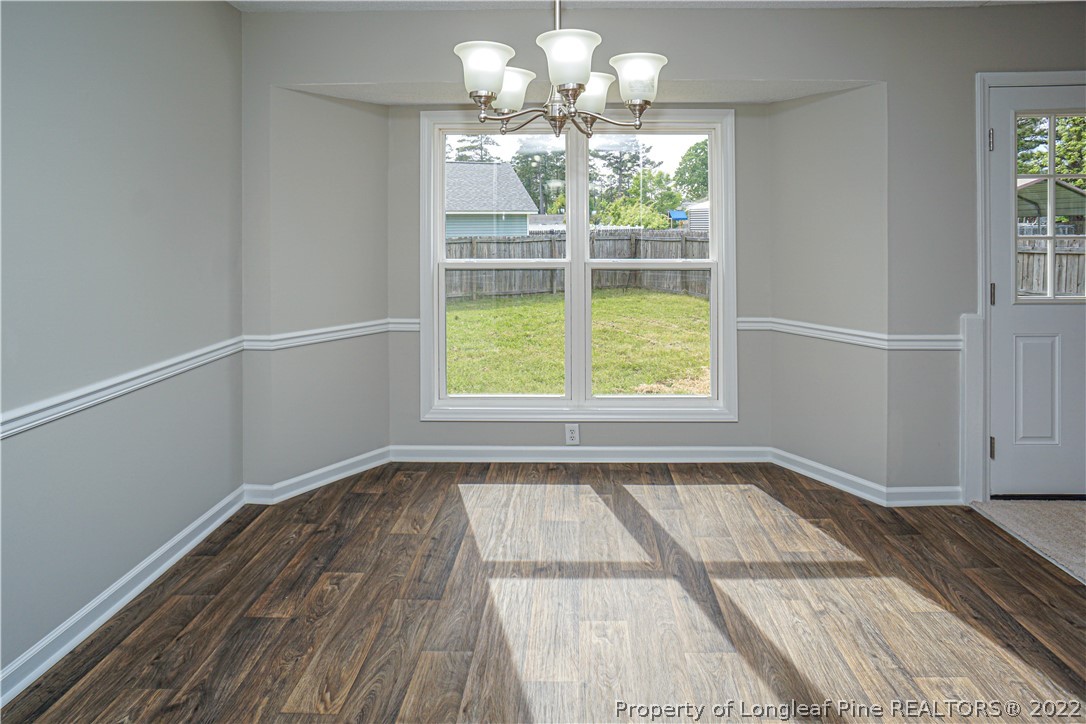 974 Rim Road Fayetteville, NC 28314 - Photo 11 of 40 a view of a room with wooden floor and chandelier