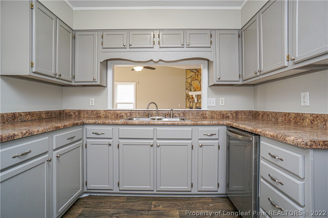 974 Rim Road Fayetteville, NC 28314 - Photo 12 of 40 a kitchen with granite countertop white cabinets and white appliances