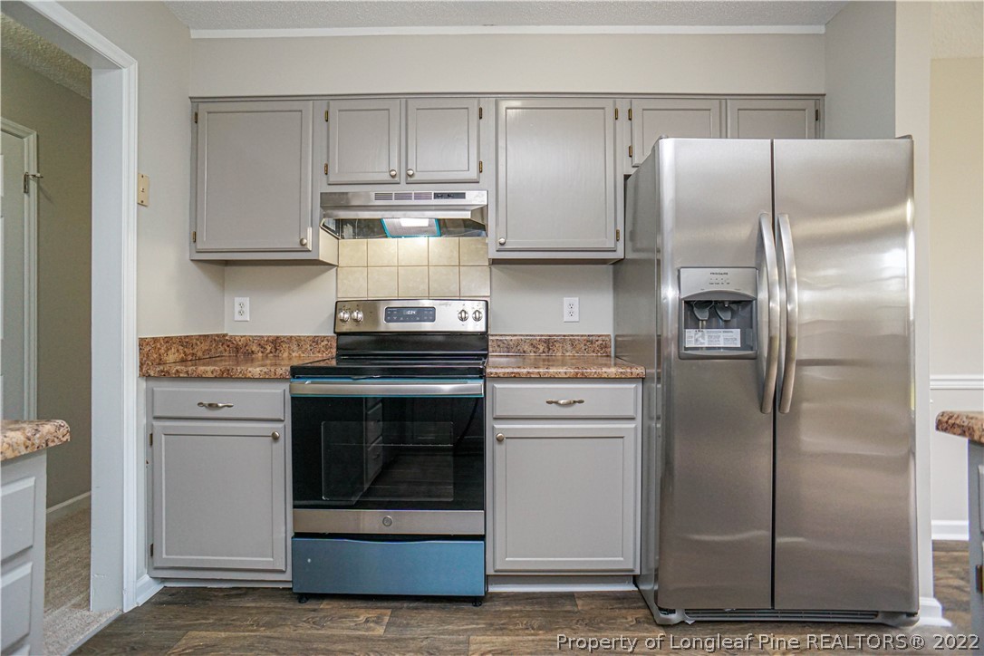 974 Rim Road Fayetteville, NC 28314 - Photo 13 of 40 a kitchen with a refrigerator sink and cabinets