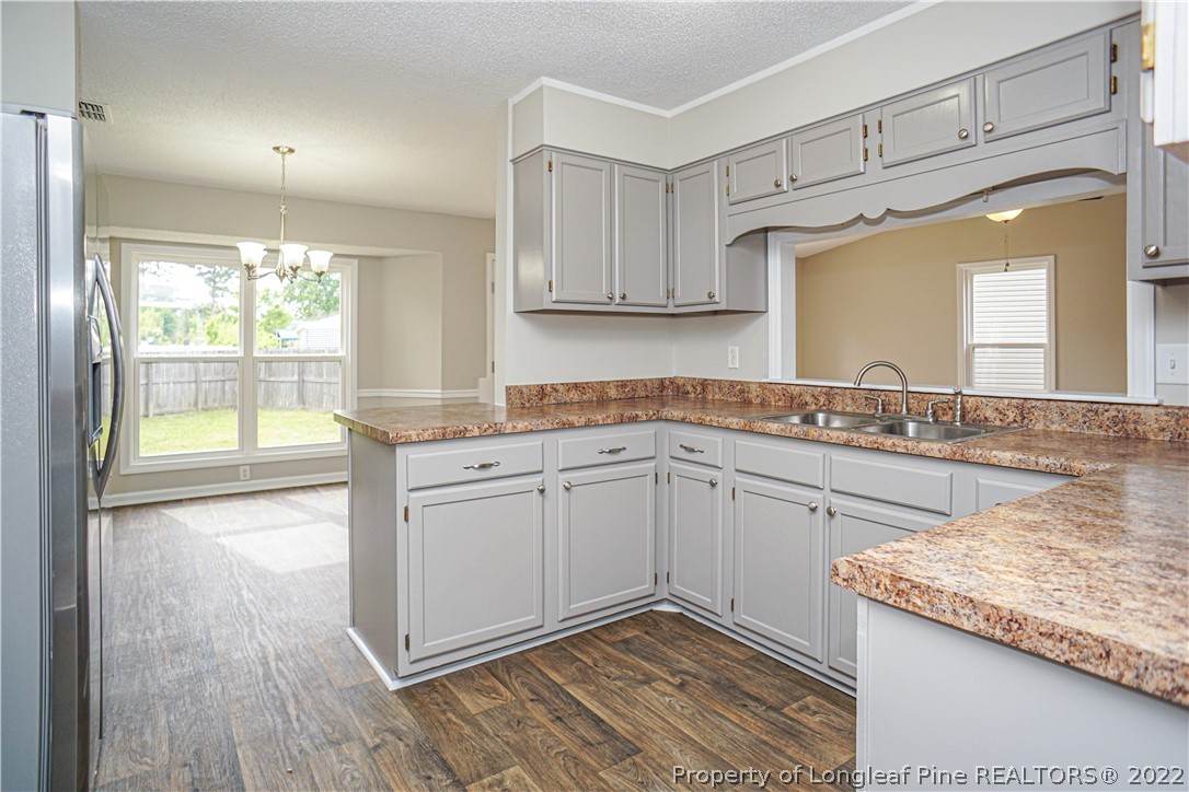 974 Rim Road Fayetteville, NC 28314 - Photo 14 of 40 a kitchen with granite countertop cabinets stainless steel appliances a sink and a large window