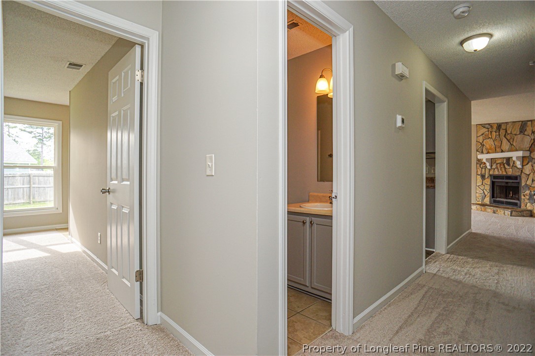 974 Rim Road Fayetteville, NC 28314 - Photo 25 of 40 a view of a hallway with a livingroom and a bathroom