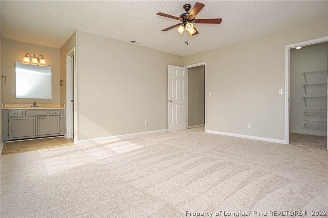 974 Rim Road Fayetteville, NC 28314 - Photo 29 of 40 a view of a big room with wooden floor and a chandelier fan in a room