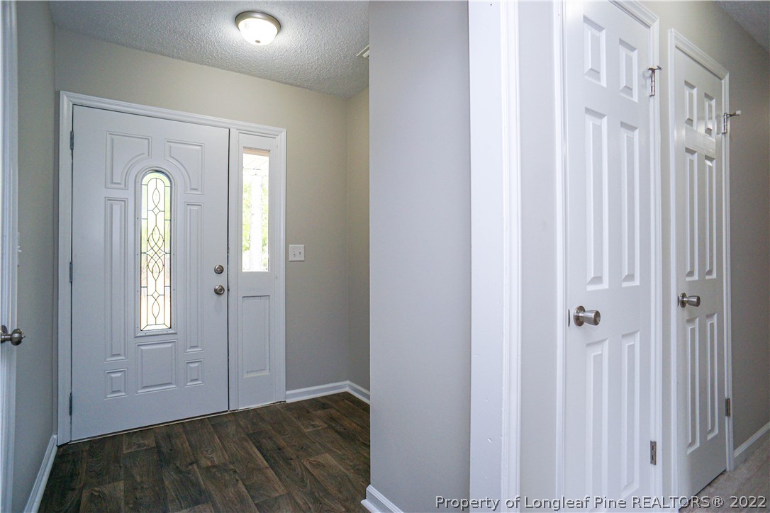 974 Rim Road Fayetteville, NC 28314 - Photo 3 of 40 a view of a room with wooden floor and front door